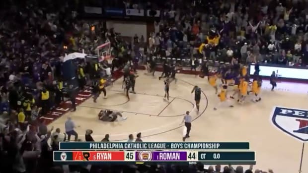 Screenshot from broadcast video of Philadelphia Catholic League boys championship showing one team celebrating and the other despondent